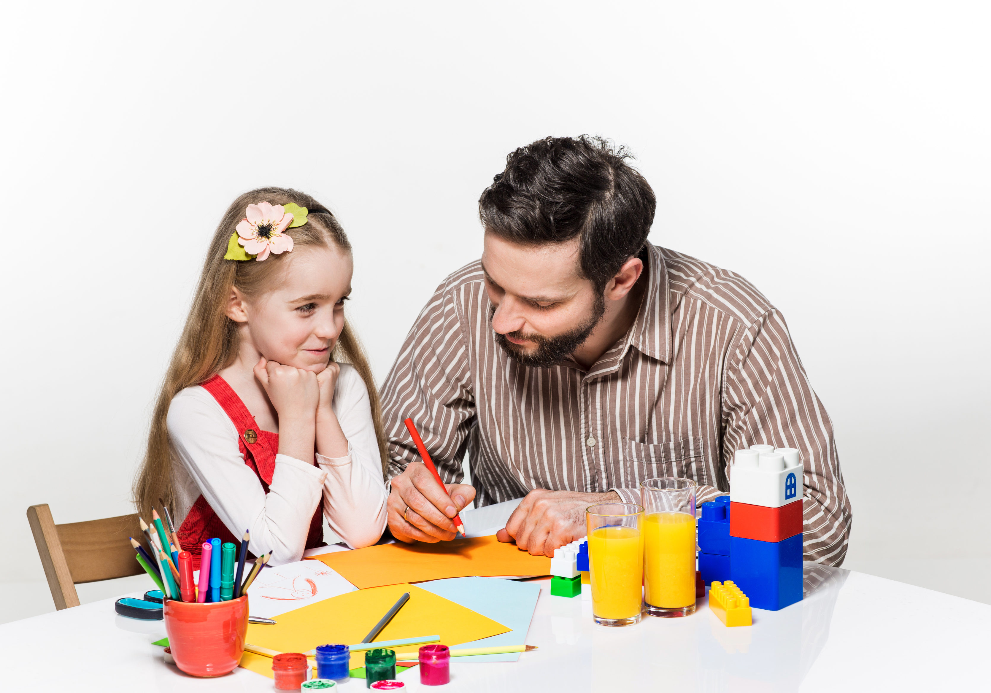 The daughter and father drawing and writing together on white background
